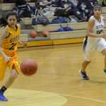 Photo by Jeff Helminiak/Peninsula Clarion Kodiak's Honey Rose Macatuno collects the ball as Arianne Parrish closes in on defense Thursday at Nikiski High School.