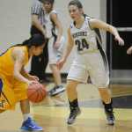 Photo by Jeff Helminiak/Peninsula Clarion Kodiak's Rica Gongora dribbles against Nikiski's Kelsey Clark on Thursday at Nikiski High School.