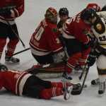 Photo by Jeff Helminiak/Peninsula Clarion Kenai River Brown Bears defenseman Croix Evingson tries unsuccessfully to stuff a goal past Minnesota Wilderness netminder Chase Munroe and a whole host of players Friday at the Soldotna Regional Sports Complex.