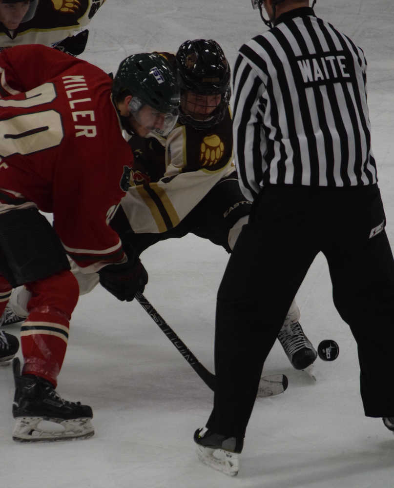 Photo by Jeff Helminiak/Peninsula Clarion Minnesota Wilderness forward Aaron Miller and Kenai River Brown Bears forward Evan Butcher battle for a faceoff Friday at the Soldotna Regional Sports Complex.