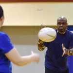 Ben Boettger/Peninsula Clarion Ann Marie (left) passes to Tony Gorman during a warm-up exercise at the Kenai Wolfpack Rugby club introductory clinic on Tuesday, Jan. 19 at Soldotna Prepatory School. Marie and Gorman both played rugby for the first time at the clinic.