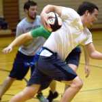 Ben Boettger/Peninsula Clarion Eric Hanneman attempts to pass Dustin Henkin (in green) at the Kenai Wolfpack Rugby club introductory clinic on Tuesday, Jan. 19 at Soldotna Prepatory School.