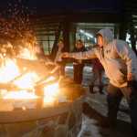 Photo by Megan Pacer/Peninsula Clarion Soldotna resident Abraham Anasogak throws a plant offering into the flames of a Raven Fire Circle during a healing gathering called "You and Me" on Wednesday, Jan. 20, 2016 at the Dena'ina Wellness Center in Kenai, Alaska. The gatherings are held periodically to support those affected by suicide or death, and have lavender, sage and sweetgrass available for participants to burn in the healing process.