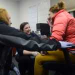Photo by Megan Pacer/Peninsula Clarion Holly Behrens, left, and Amanda Dorough, center, attend to Jessica Roper, right, while she poses as a patient during an emergency response drill on Tuesday, Jan. 19, 2016 at the Central Emergency Services Station 4 on Kalifornski-Beach Road near Kenai, Alaska. CES hosts drill nights each Tueasday so full-time staff and members of the volunteer program can stay up to date on their training.