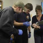 Photo by Megan Pacer/Peninsula Clarion Central Emergency Services Volunteer Megan Nathe inspects the lights and functions of one of CES's vehicles on Wednesday, Jan. 13, 2016 at the CES Station 6 in Kasilof, Alaska. Nathe, a member of the volunteer program's inaugural class, is also part of the department's resident program, and lives at Station 6 full-time.