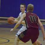 Photo by Joey Klecka/Peninsula Clarion Soldotna sophomore Caleb Spence looks for an opening against Grace Christian senior Trevor Osborne (10) Friday at the Soldotna Prep gymnasium. Grace defeated SoHi 56-50.