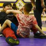 Ben Boettger/Peninsula Clarion Samiel Wilson (left) prepares to go against Seth Strange in the arm pull event of the Native Youth Olympics Winter Games Invitational on Saturday, Jan. 23 at Kenai Middle School.