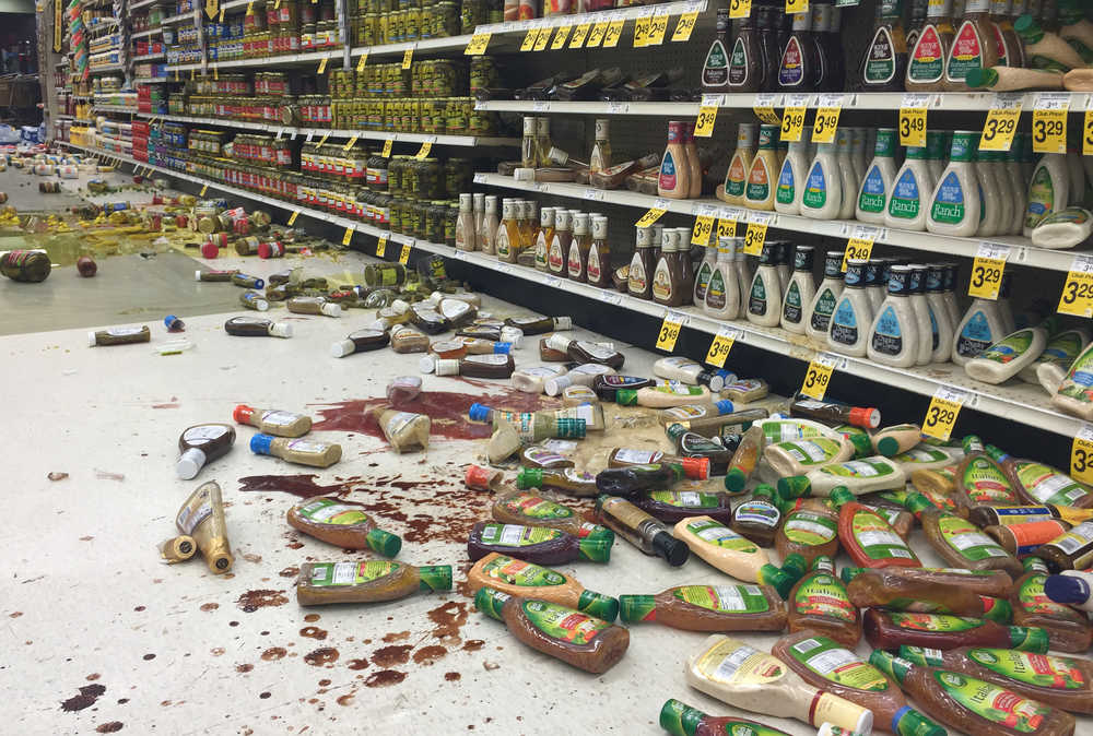 Photo by Megan Pacer/Peninsula Clarion Robin and Shannon Muster relax with their daughter, six-year-old Effie, in a temporary shelter after being evacuated from their home on Lilac Lane on Sunday, Jan. 24, 2016 at the Kenai National Guard Armory in Kenai, Alaska. A 7.1 magnitude earthquake caused gas explosions on Lilac Lane.