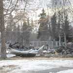 Photo by Megan Pacer/Peninsula Clarion Burnt debris litters the ground where a house used to stand on Lilac Lane on Monday, Jan. 25, 2016 in Kenai, Alaska. Gas explosions and fires took out four homes on the block following a 7.1 magnitude earthquake that hit the Lower Cook Inlet early Sunday morning.