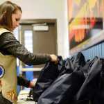 Ben Boettger/Peninsula Clarion Girl Scout Catie Kline arranges some of the 200 "comfort kits" she assembled to distribute to visitors at the Project Homeless Connect event on Thursday, Jan. 28 at the Soldotna Regional Sports Complex. The kits contained hygiene products, gloves, hats, and snacks.