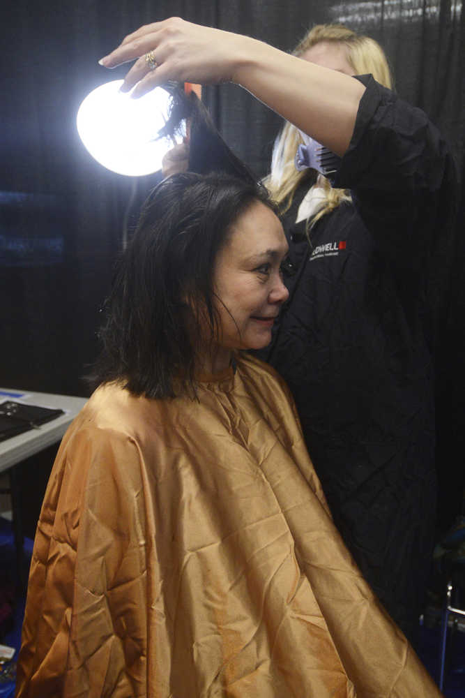 Photo by Megan Pacer/Peninsula Clarion Sandra Groller, of Kasilof, gets a haricut from Joy Conner, of Soldotna, while at Project Homeless Connect on Thursday, Jan. 28, 2016 at the Soldotna Regional Sports Complex in Soldotna, Alaska.