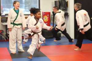 Photo by Kelly Sullivan/ Peninsula Clarion Sam Festervand warms up with a game at the start of lessons Thursday at Soldotna Martial Arts in Soldotna, Alaska. It was the first day he shook another classmate, said his mother Denise Festervan with pride.