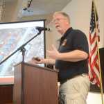 Photo by Megan Pacer/Peninsula Clarion Kenai Fire Chief Jeff Tucker explains his department's response to gas explosions and fire that followed last week's magnitude 7.1 earthquake during a briefing session on Sunday, Jan. 31, 2016 at the Kenai Chamber of Commerce and Visitor Center in Kenai, Alaska. Gov. Bill Walker heard from Tucker, city and borough public officials, and local utility companies about the aftermath of the quake.