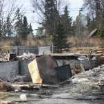 Photo by Megan Pacer/Peninsula Clarion Debris covers the ground where a house once stood on Sunday, Jan. 31, 2016 on Lilac Lane in Kenai, Alaska. Two homes exploded and another two caught on fire after a 7.1 magnitude earthquake rocked the Kenai Peninsula on Jan. 24.
