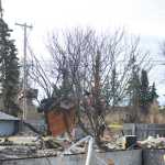 Photo by Megan Pacer/Peninsula Clarion Debris hangs in a tree and covers the ground and where a house once stood on Sunday, Jan. 31, 2016 on Lilac Lane in Kenai, Alaska. Two homes exploded and another two caught on fire after a 7.1 magnitude earthquake rocked the Kenai Peninsula on Jan. 24.