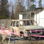 Photo by Megan Pacer/Peninsula Clarion A destroyed car rests on the lot where a house once stood on Sunday, Jan. 31, 2016 on Lilac Lane in Kenai, Alaska. Two homes exploded and another two caught on fire after a 7.1 magnitude earthquake rocked the Kenai Peninsula on Jan. 24.