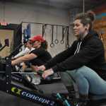 Photo by Elizabeth Earl/Peninsula Clarion (From right) Brittany Jackson, the co-owner of CrossFit Kainos, rows with Nancy Saylor, Lauri Winslow and Becki Metz on Monday. Saylor and Winslow, members of the Alaska Midnight Sun Rowing Association, coach rowing classes Mondays and Wednesdays at the gym, located next to Beemun's Variety in Soldotna.