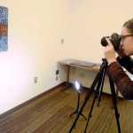 Ben Boettger/Peninsula Clarion Painter Amy Kruse photographs a new painting using lights, a tripod, and a camera made available for artists to copy their work at the Soldotna Public Library on Wednesday, Feb. 3 in Soldotna.
