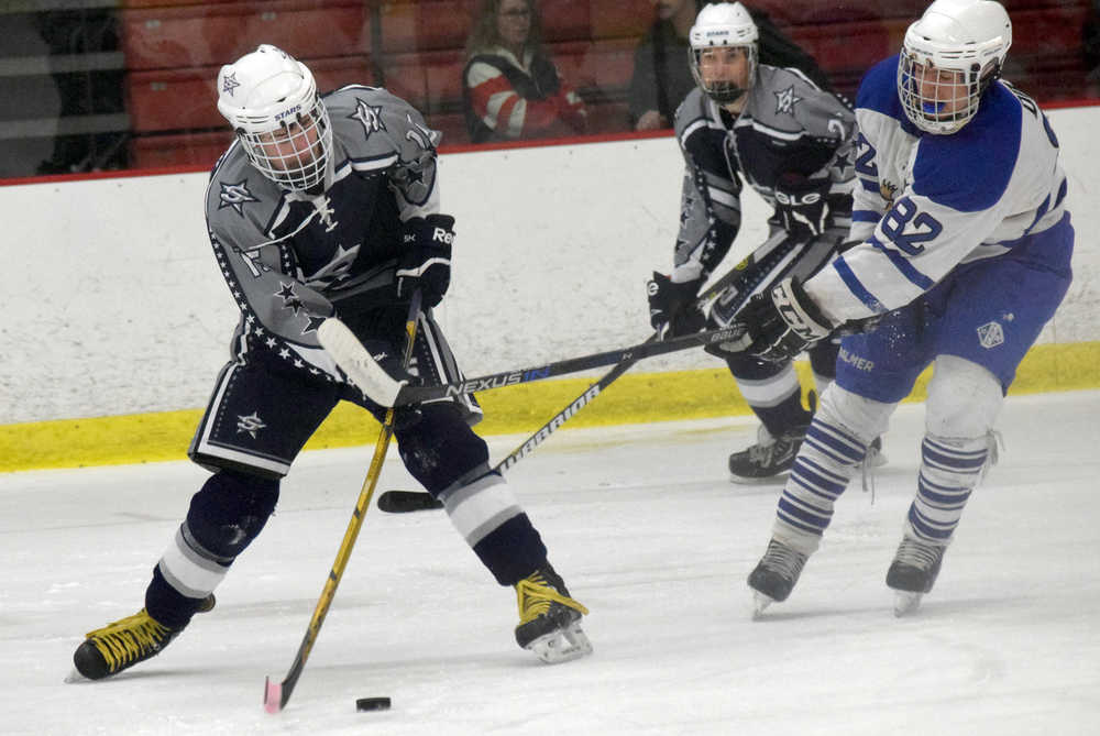 Photo by Jeff Helminiak/Peninsula Clarion Soldotna's Matthew Daugherty fires a shot on goal as Palmer's Valary Dietz defends Friday at the North Star Conference hockey tournament at the Soldotna Regional Sports Complex.