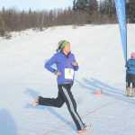 Photo by Megan Pacer/Peninsula Clarion Soldotna resident Megan Anderson crosses the finish line of the Women's Stud Run on Sunday, Feb. 7, 2016 at the Tsalteshi Trails in Soldotna, Alaska. Formerly the Ski for Women, the Stud Run allowed participants to choose between skis, shoes or snowshoes for the 5K race.