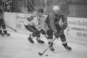 Photo by Joey Klecka/Peninsula Clarion Soldotna junior Levi Hensley (17) looks for a scoring opportunity on the Colony Knights, as Colony sophomore Foster Riekena looks on. Soldotna faces the Chugiak Mustangs in today's first round of the Class 4A state hockey tournament.
