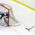 Photo by Joey Klecka/Peninsula Clarion Soldotna sophomore goalie Billy Yoder (left) tracks the puck with Chugiak junior Zach Krajnik in the second period of Thursday's Class 4A state hockey tournament quarterfinal.