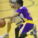 Photo by Jeff Helminiak/Peninsula Clarion Soldotna's Dylan Kuntz goes for a steal on Kodiak's Billy Alcaide on Friday at Soldotna High School.