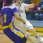 Photo by Jeff Helminiak/Peninsula Clarion Soldotna's Eli Sheridan drives on Kodiak's Billy Alcaide on Friday at Soldotna High School.