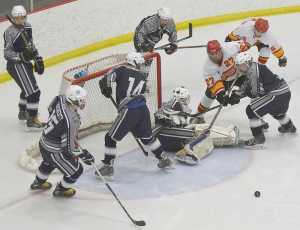 Photo by Joey Klecka/Peninsula Clarion Soldotna junior Matthew Daugherty (15), freshman Wyatt Harvey (14), sophomore Billy Yoder and junior Jace Urban watch as the puck rebounds away from the net in Friday's 4A state hockey tournament consolation semifinal at the Curtis Menard Sports Complex in Wasilla. West Valley beat Soldotna 7-1.