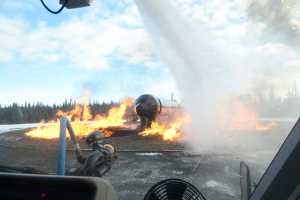 Kenai Fire Marshal Tommy Carver takes a turn using a fire engine to put out a simulated aircraft fire during an Aircraft Rescue and Firefighting drill on Monday, Feb. 15, 2016 at the Beacon Occupational Health and Safety Services Training Center in Kenai, Alaska.