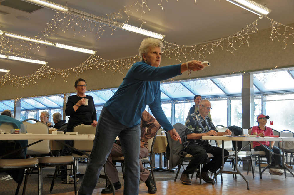 Photo by Elizabeth Earl/Peninsula Clarion Dorothy Diamond takes a swing at Wii Bowling during the Senior Olympics Tuesday, Feb. 16, 2016, at the Kenai Senior Center.