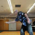 Photo by Elizabeth Earl/Peninsula Clarion Denny Thomas takes a swing at the Wii Bowling event of the Senior Olympics at the Kenai Senior Center Tuesday, Feb. 16, 2016.