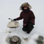 Cindy Detrow cooks up some goodies in a Dutch oven, adding to the enjoyment of ice fishing. (Photo courtesy Dave Atcheson)