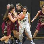 Photo by Joey Klecka/Peninsula Clarion Nikiski junior Brianna Vollertsen (12) keeps her eye on the ball, held by Grace Christian senior Hayley Hagen, Thursday at Nikiski High School.