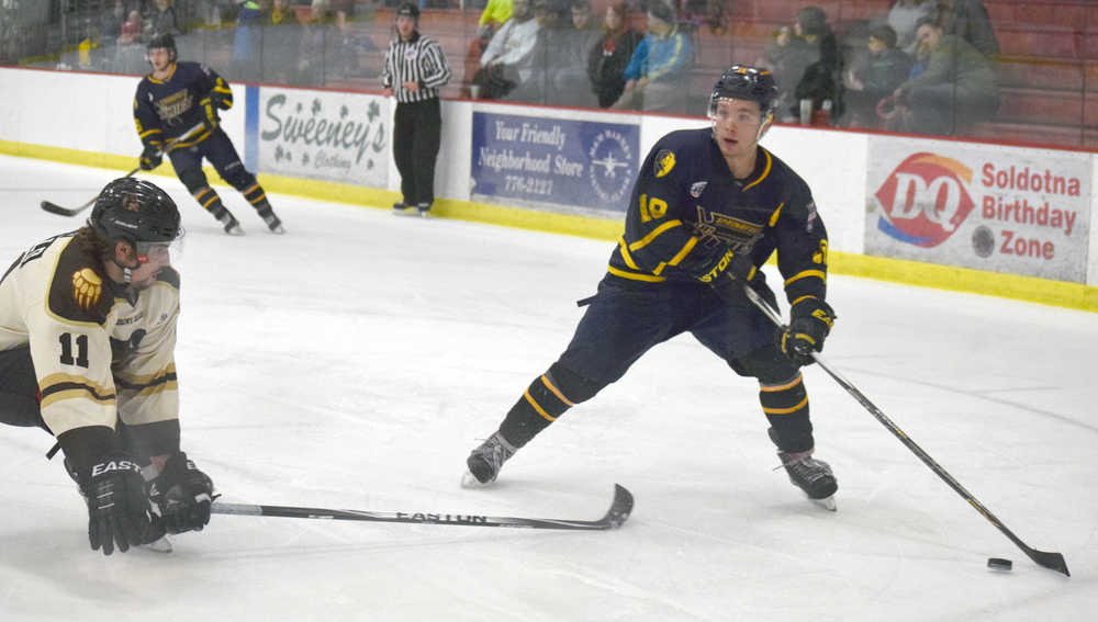 Photo by Jeff Helminiak/Peninsula Clarion Kenai River Brown Bears defenseman Davis Sebald defends Springfield Jr. Blues forward Trevor Stone on Friday at the Soldotna Regional Sports Complex.