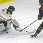 Photo by Jeff Helminiak/Peninsula Clarion Springfield Jr. Blues defenseman Anthony Scarsella scores the game-winning goal in the shootout on Kenai River Brown Bears goalie Nick Nast on Friday at the Soldotna Regional Sports Complex.