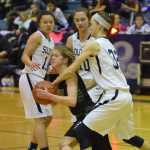 Photo by Joey Klecka/Peninsula Clarion Colony guard Amanda Smith (center) is mobbed by Soldotna defenders (left to right) Lindsey Wong, Aliann Schmidt and Danica Schmidt Saturday at Soldotna High School. The Knights defeated the Stars 43-25.