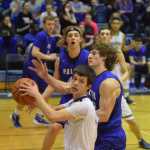 Photo by Joey Klecka/Peninsula Clarion Soldotna senior Dylan Kuntz looks for a teammate to pass to while Palmer forward Chase Ferris and Michael Kluting look on.