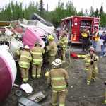 CES Captain Lesley Quelland and other first responders from CES tend to the aftermath of a cemet truck rollover on Kalifornsky Beach Road and the Sterling Highway.