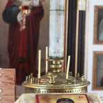 Father Mark Dean displays a traveling icon of Jesus and Mary he painted on a stone. Dean said the icon is based on the medieval Byzantine Theotokos of Vladimir and includes features that distinguish Eastern Orthodox depictions of Mary from Catholic images: red robes, and stars on her shoulders and forehead.