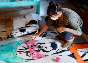 Gemma Amorelli scruffs her pet ferret Margy on Monday, Feb. 22 near Soldotna. Like kittens, ferrets become relaxed and docile when held by the scruff of the neck.