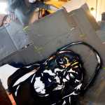 Spraypaint artist Gemma Amorelli adds free-hand embellishments to a stenciled portrait of a friend on Monday, Feb. 22 near Soldotna.