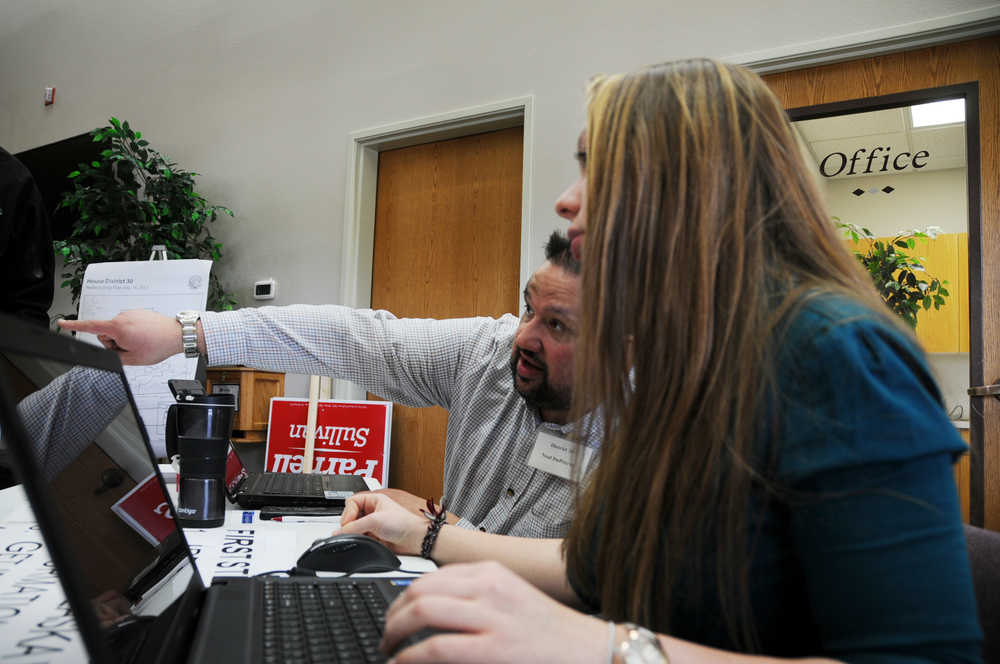 Photo by Elizabeth Earl/Peninsula Clarion Ellie Smardo (right) and Neal DuParran (left), both volunteers with the Alaska Republican Party, helped direct voters at the Kenai New Life Church during the Republican Presidential Preference Poll on Tuesday, March 1, 2016.