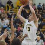 Photo by Joey Klecka/Peninsula Clarion Ninilchik guard Pat Brandt takes a shot over a crowd of Seldovia defenders in Friday night's Peninsula Conference championship game at Homer High School.