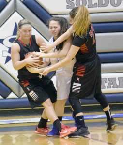 Photo by Jeff Helminiak/Peninsula Clarion Kenai Central's Hannah Drury rips the ball from Soldotna's Melia Miller as Kenai's Alexis Baker helps Saturday at Soldotna High School.