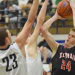 Photo by Joey Klecka/Peninsula Clarion Kenai Central forward Garrett Fitt (24) shoots over Soldotna defenders Derek Evans (23) and Caleb Spence Thursday at the Northern Lights Conference tournament at Palmer High School.