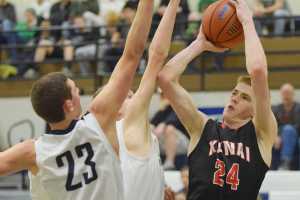 Photo by Joey Klecka/Peninsula Clarion Kenai Central forward Garrett Fitt (24) shoots over Soldotna defenders Derek Evans (23) and Caleb Spence Thursday at the Northern Lights Conference tournament at Palmer High School.