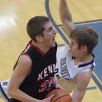 Photo by Joey Klecka/Peninsula Clarion Kenai Central guard Josh Jackman (22) drives to the hoop against Soldotna defender Timmy Smithwick Thursday at the Northern Lights Conference tournament at Palmer High School.