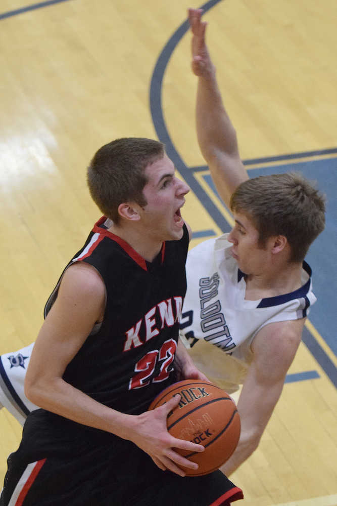 Photo by Joey Klecka/Peninsula Clarion Kenai Central guard Josh Jackman (22) drives to the hoop against Soldotna defender Timmy Smithwick Thursday at the Northern Lights Conference tournament at Palmer High School.