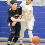 Wasilla freshman Daniel Headdings tries to knock the ball away from Kenai's Marshall Vest during a 57-50 overtime win over Kenai in the Northern Lights Conference Championships semifinals March 11, 2016, at Palmer High School.